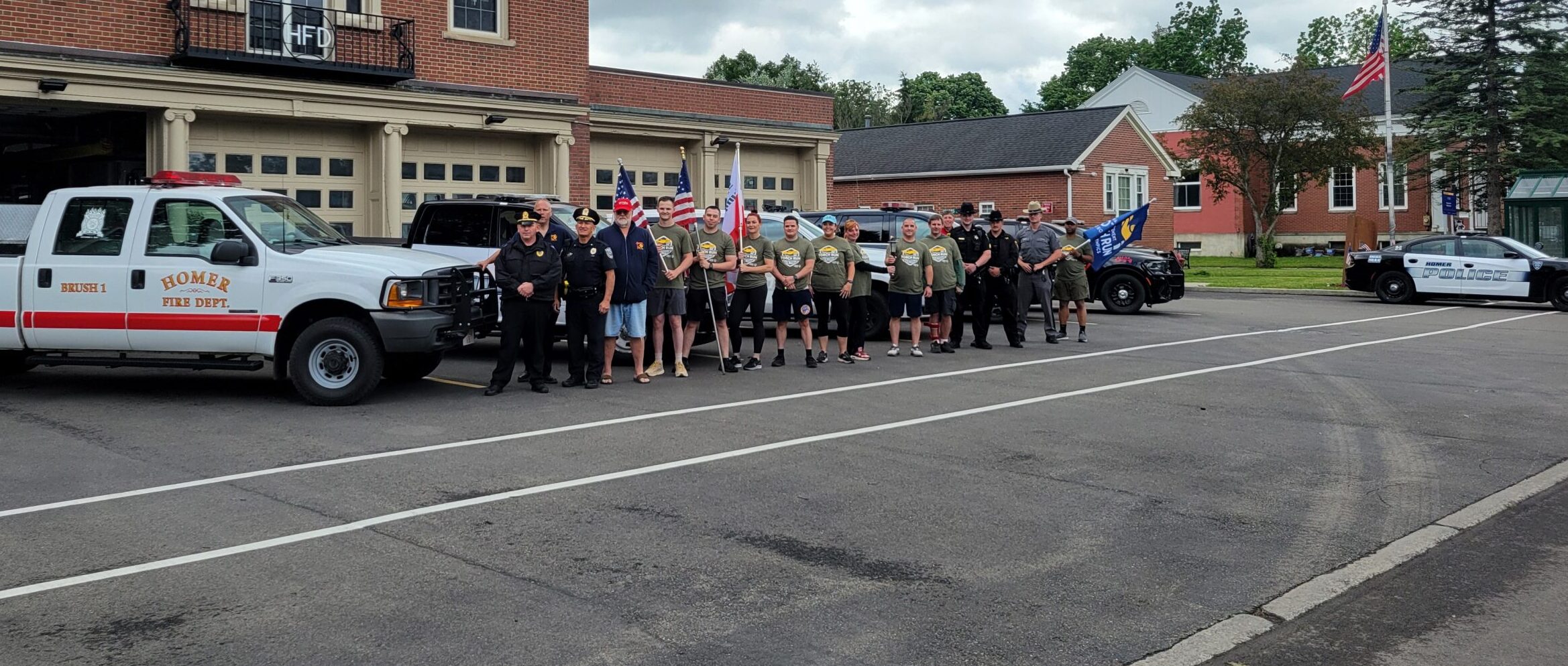 Torch Runners posing in front of the fire dept for Torch Run