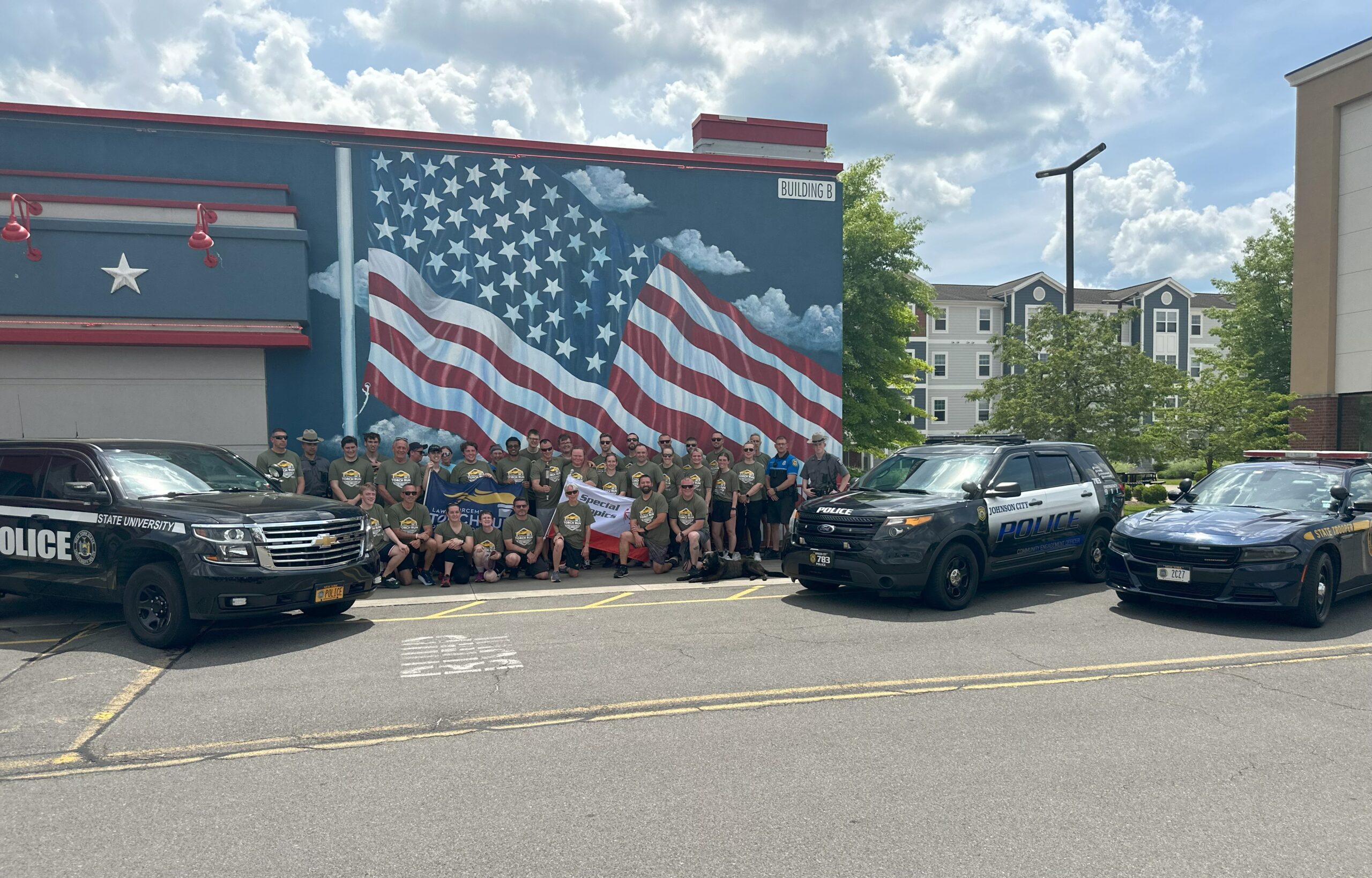 police cars and torch runners pose outside Tully's