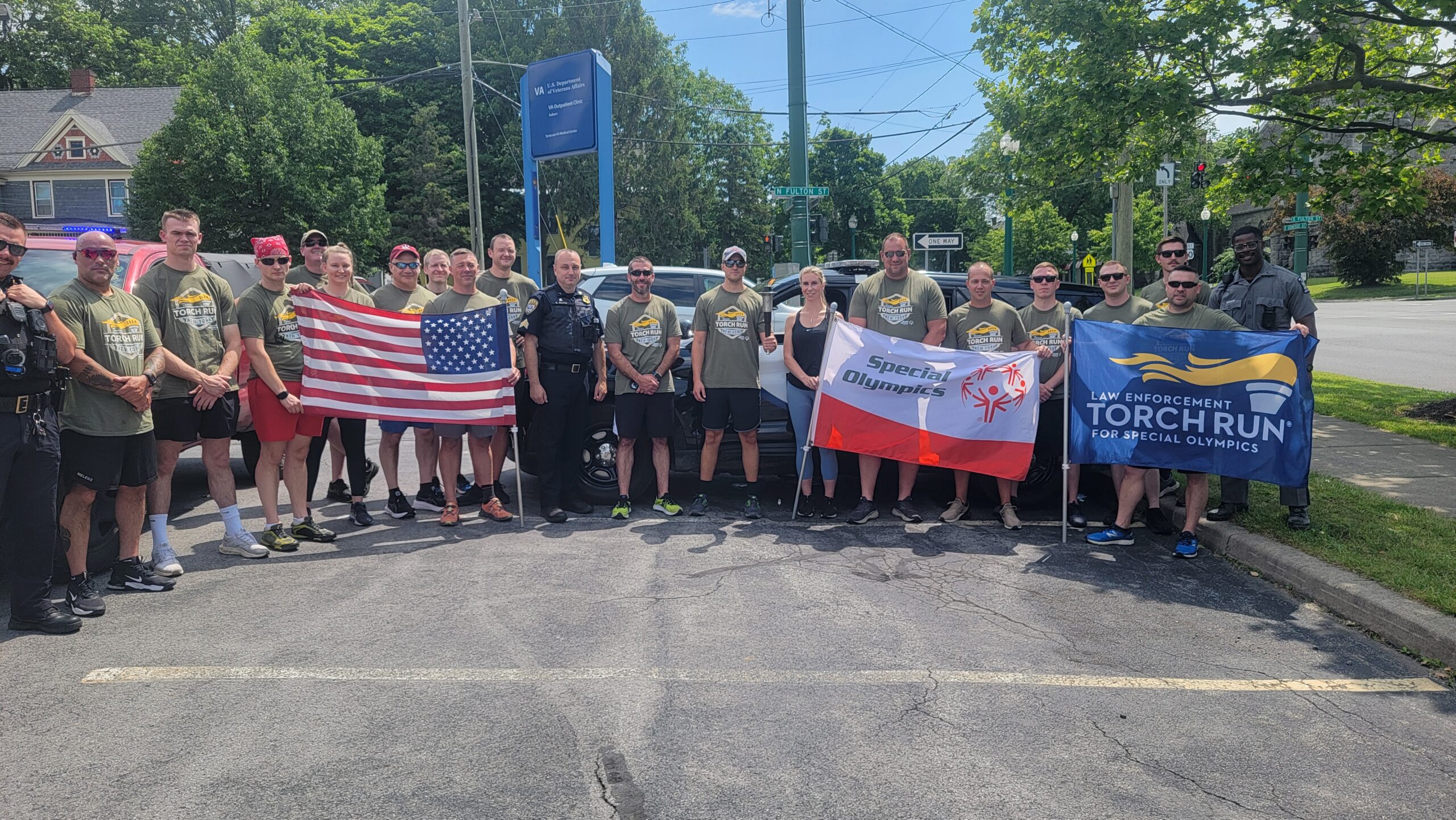 group of Torch Runners pose with flags