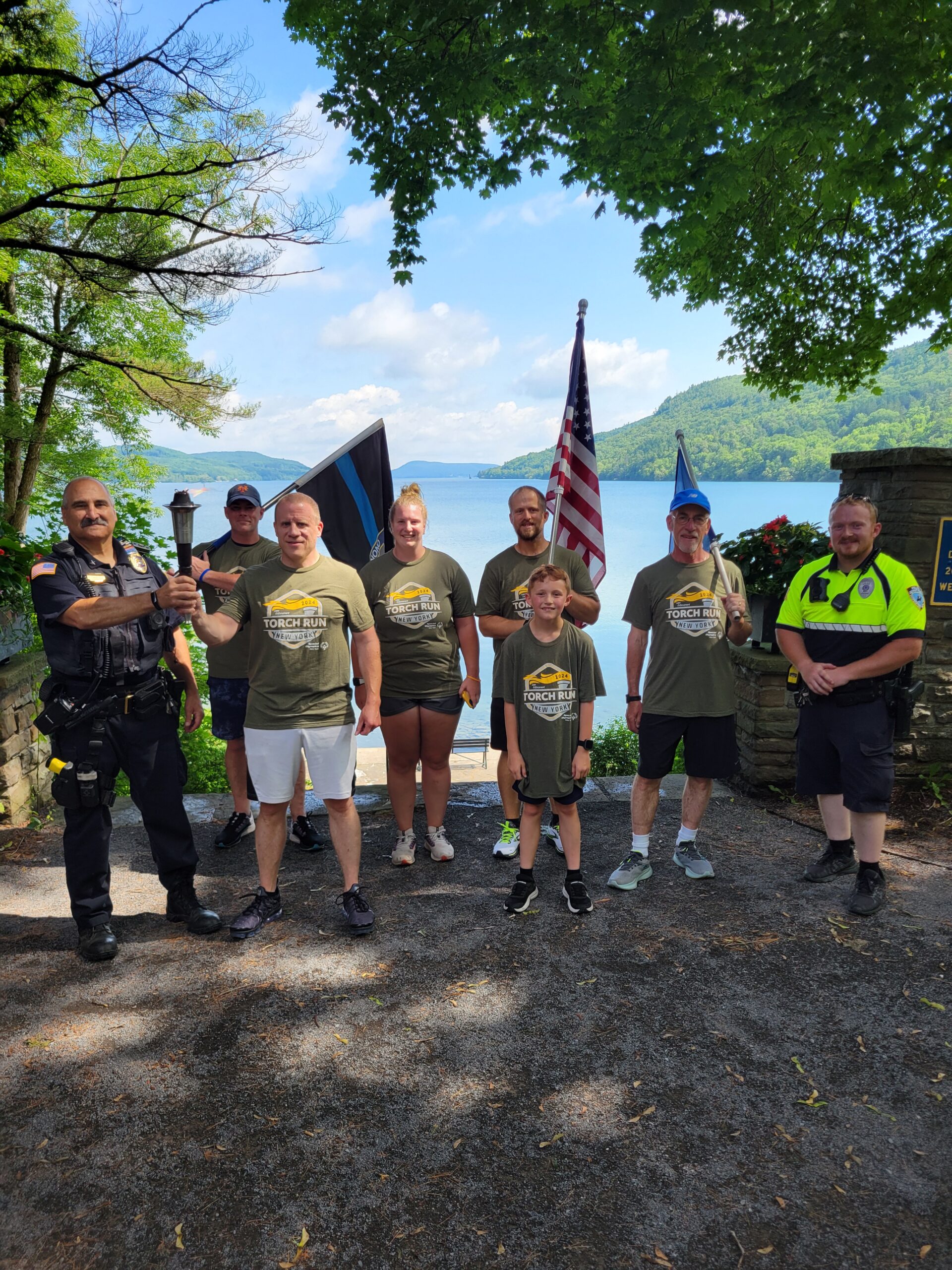 runners pose at park entrance