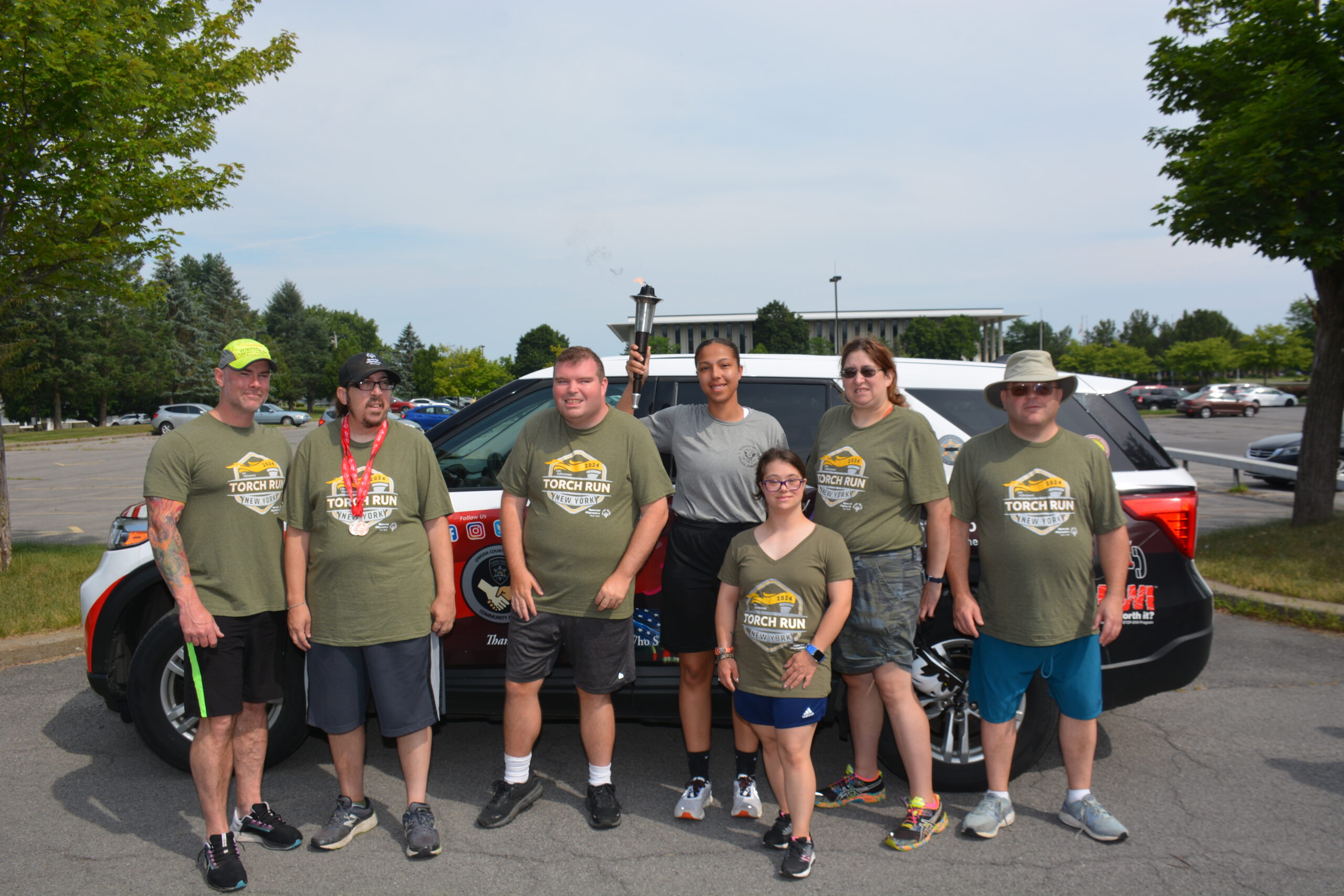 special Olympics NY athletes pose with police cruiser